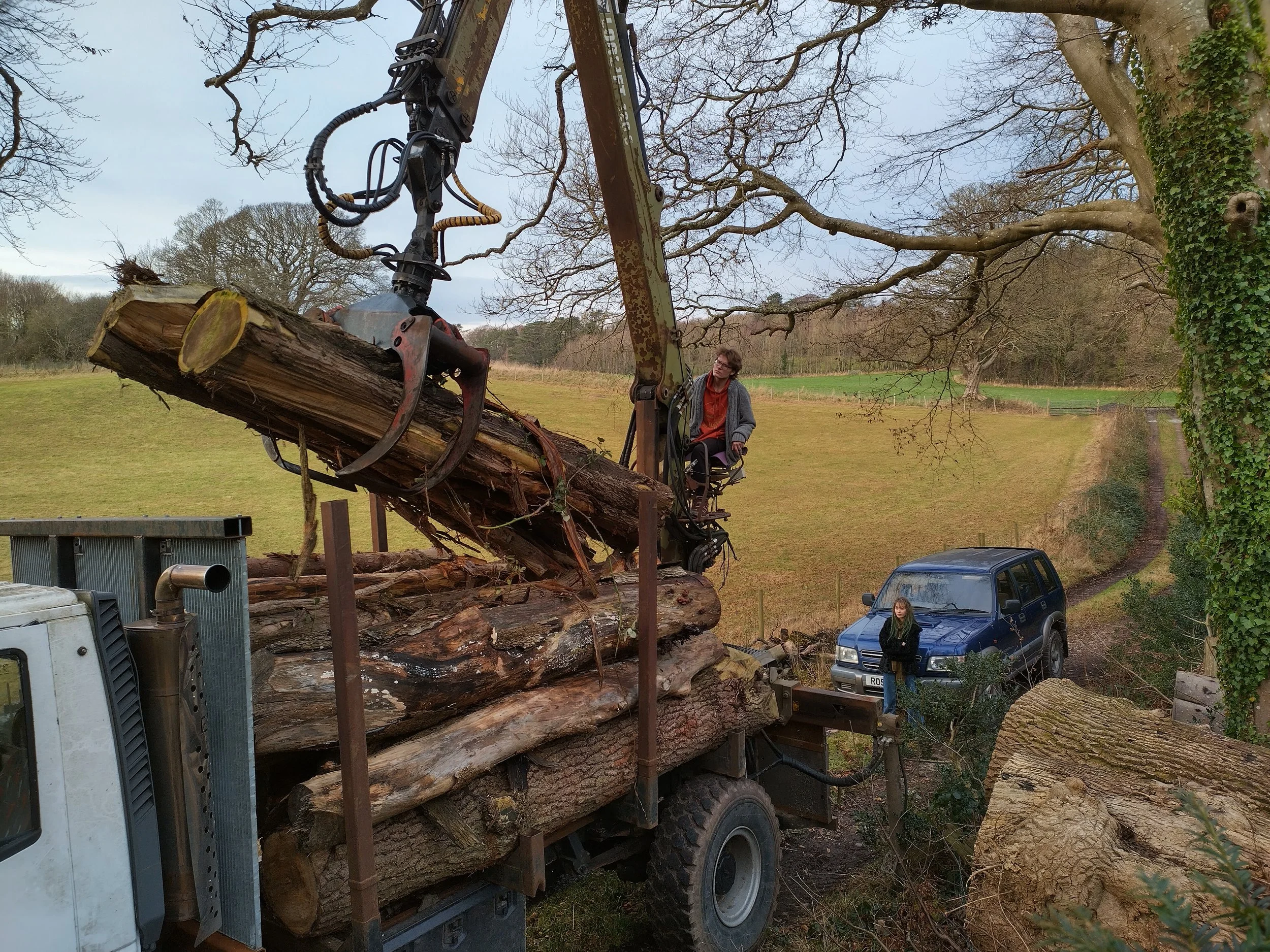 Iveco 4x4 radio remote crane truck with grapple for mechanical tree removal and heavy timber handling.