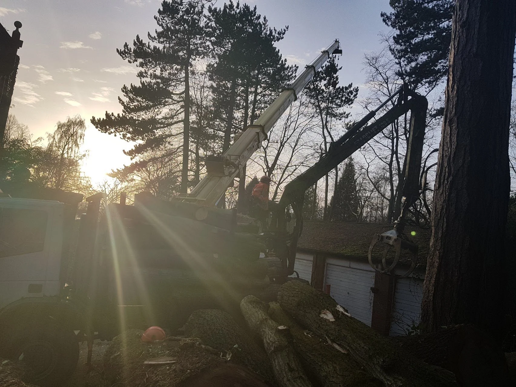 Timber grab and specialist crane moving timber on site clearance North Wales