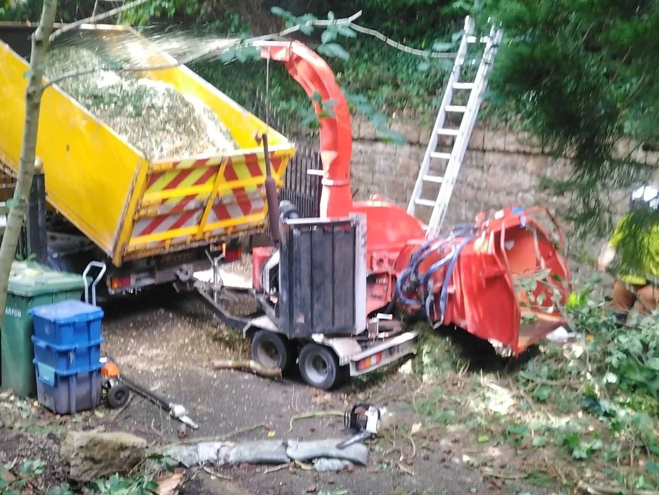 Farmi wood chipper processing branches and timber from professional tree surgery operations.