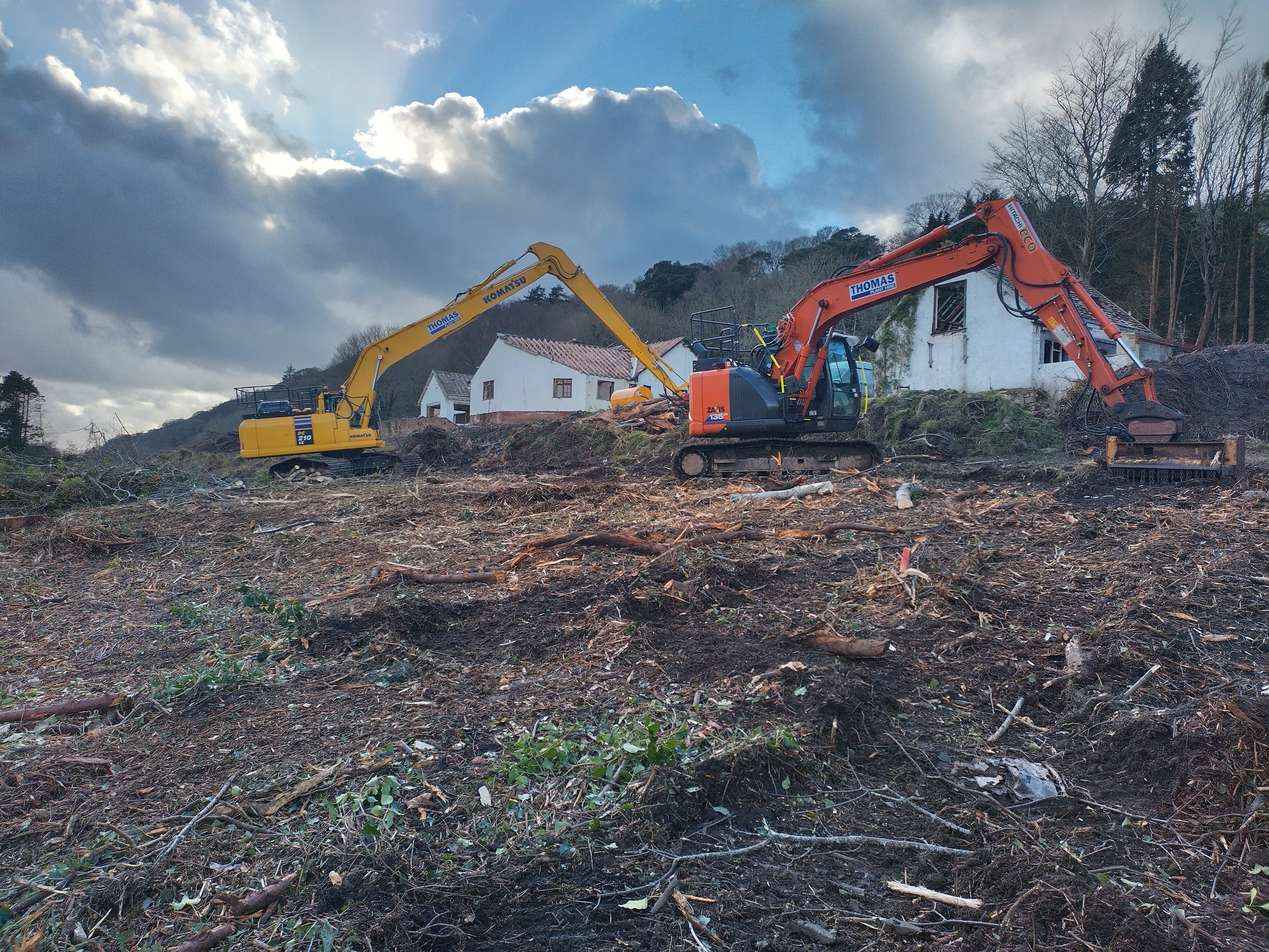Commercial land clearing and vegetation clearance preparing a site for future development in Gwynedd.