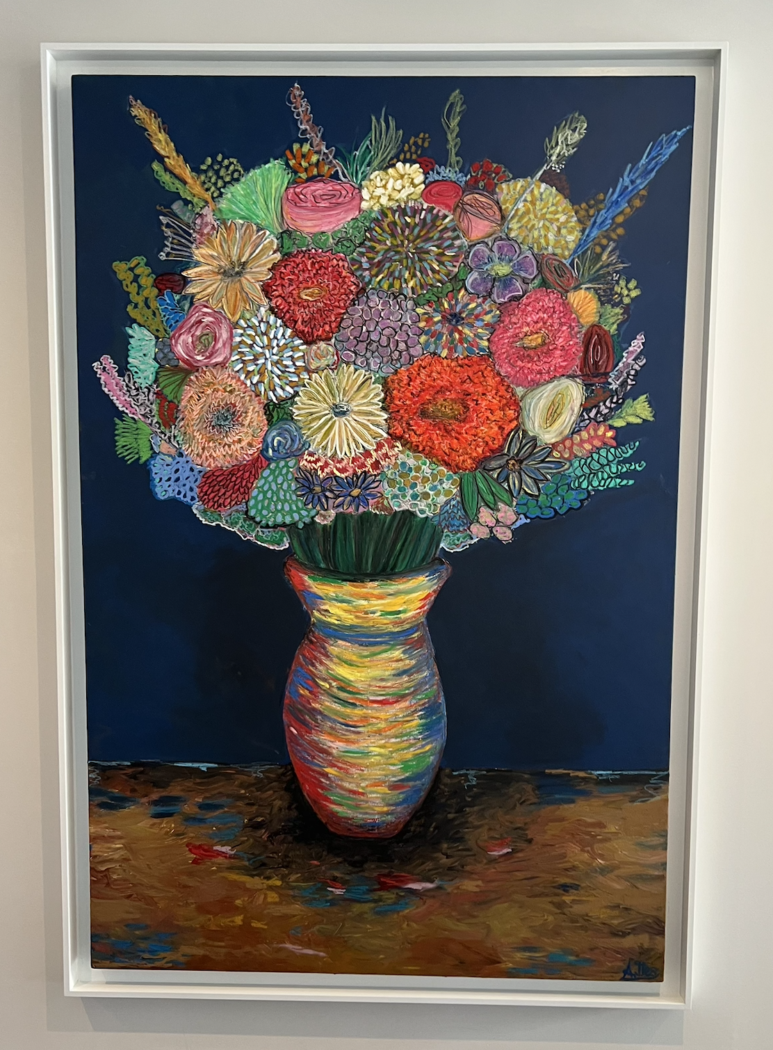 Colorful painting of a large bouquet of flowers in a striped vase on a table against a dark background.