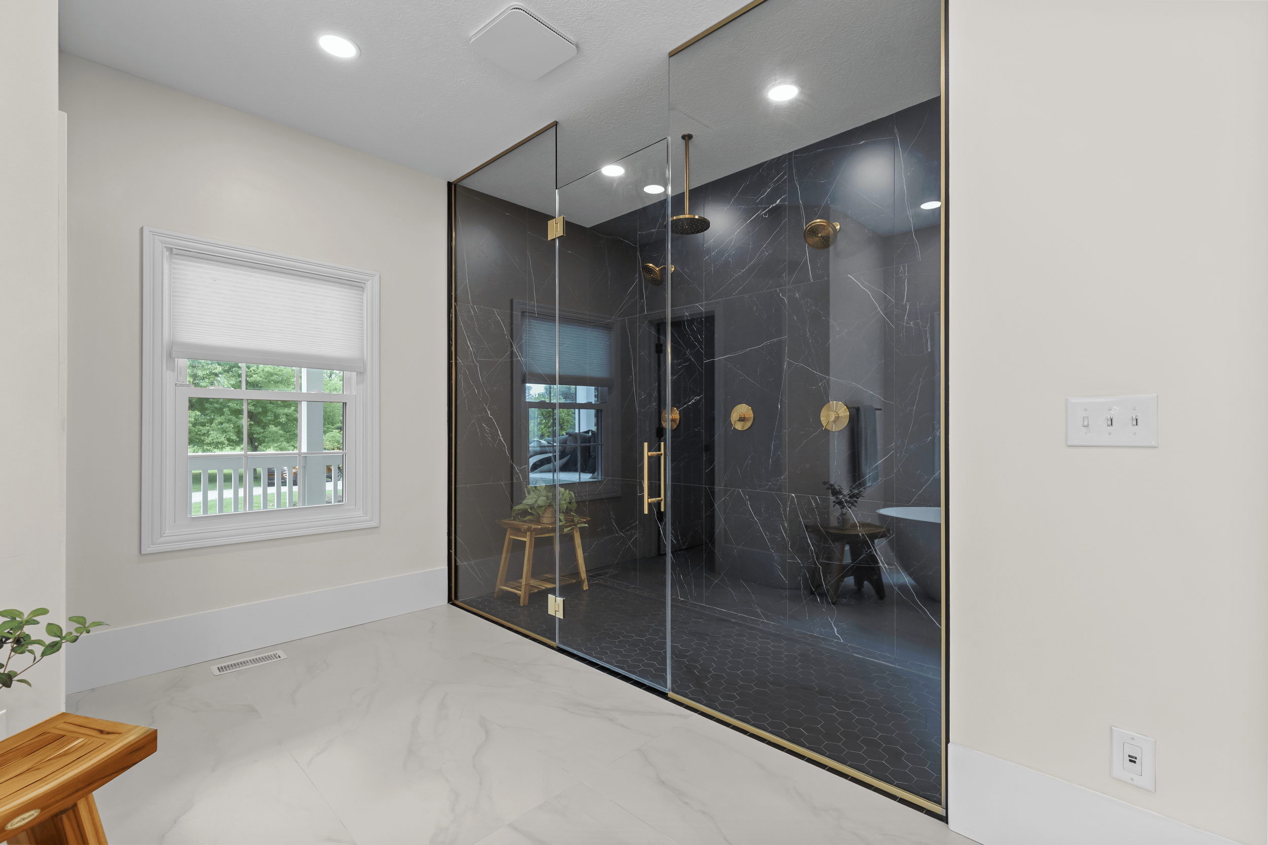 white bathroom with window open black shower and tile and marble flooring