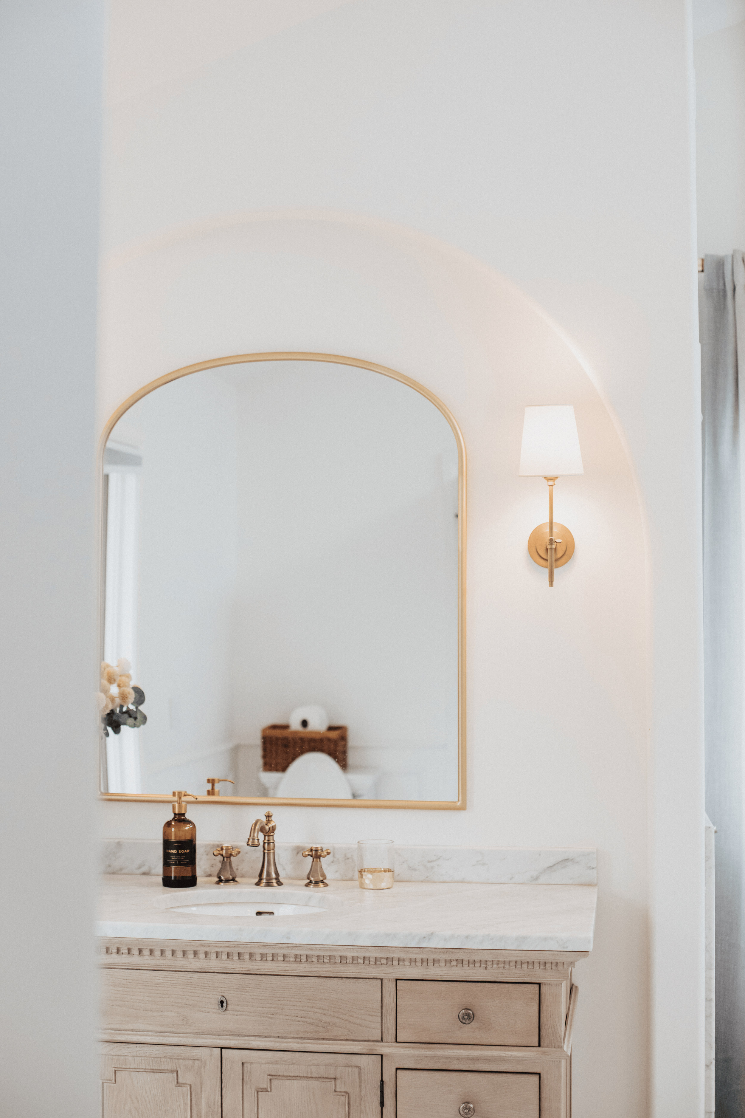 white delaware remodeled bathroom with sink, mirror, lamp, and soap