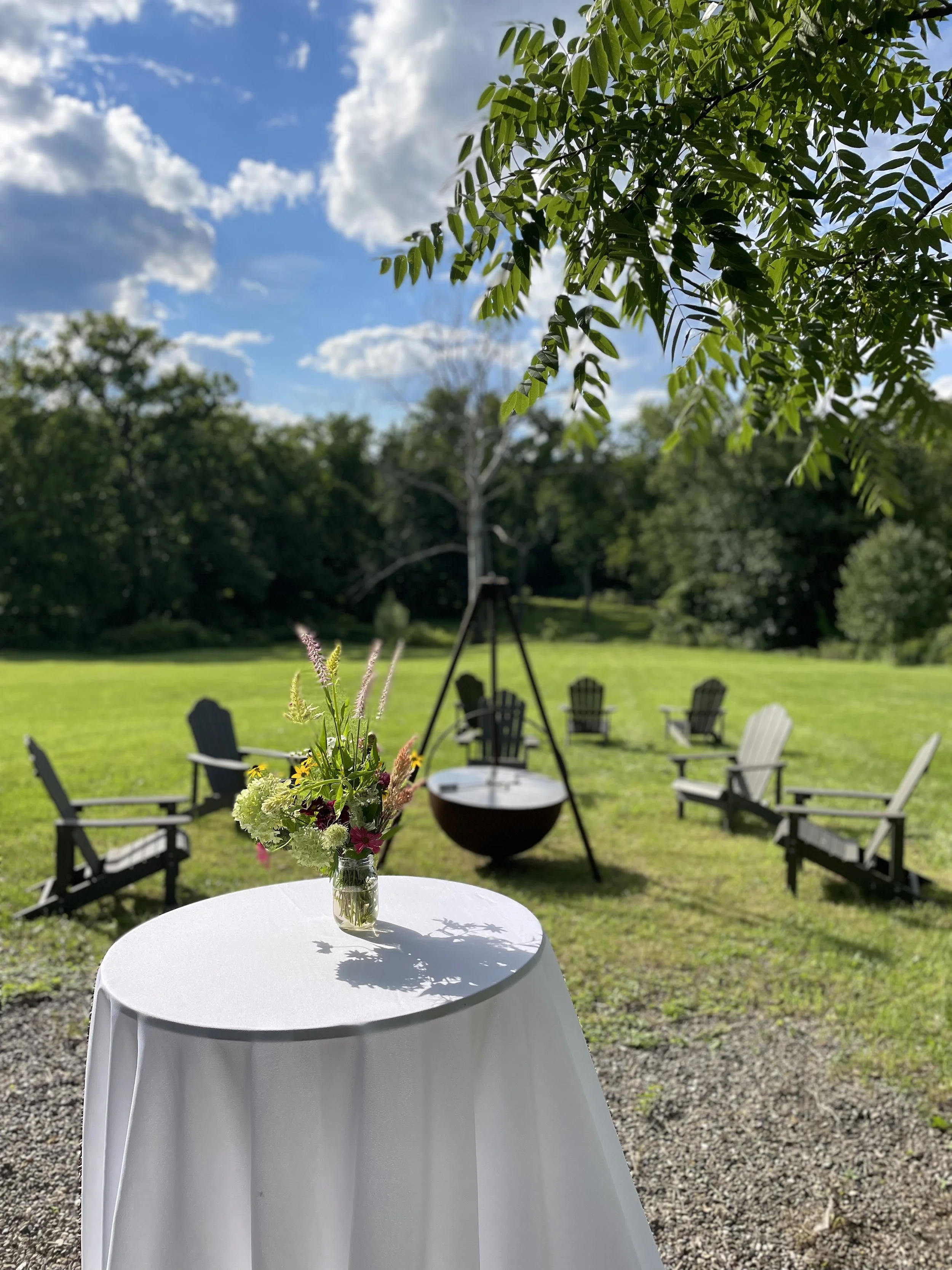 A backyard private event photo from one of our recent events showing a fresh flower bouquet and guest seating