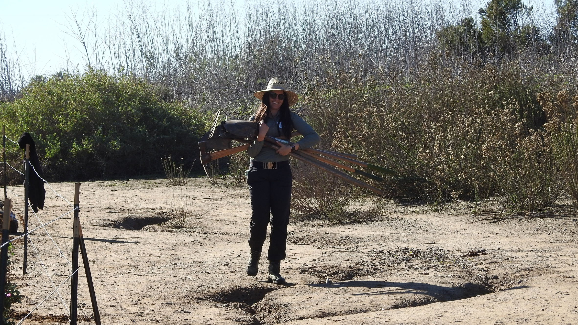 image of restoration biologists holding tools