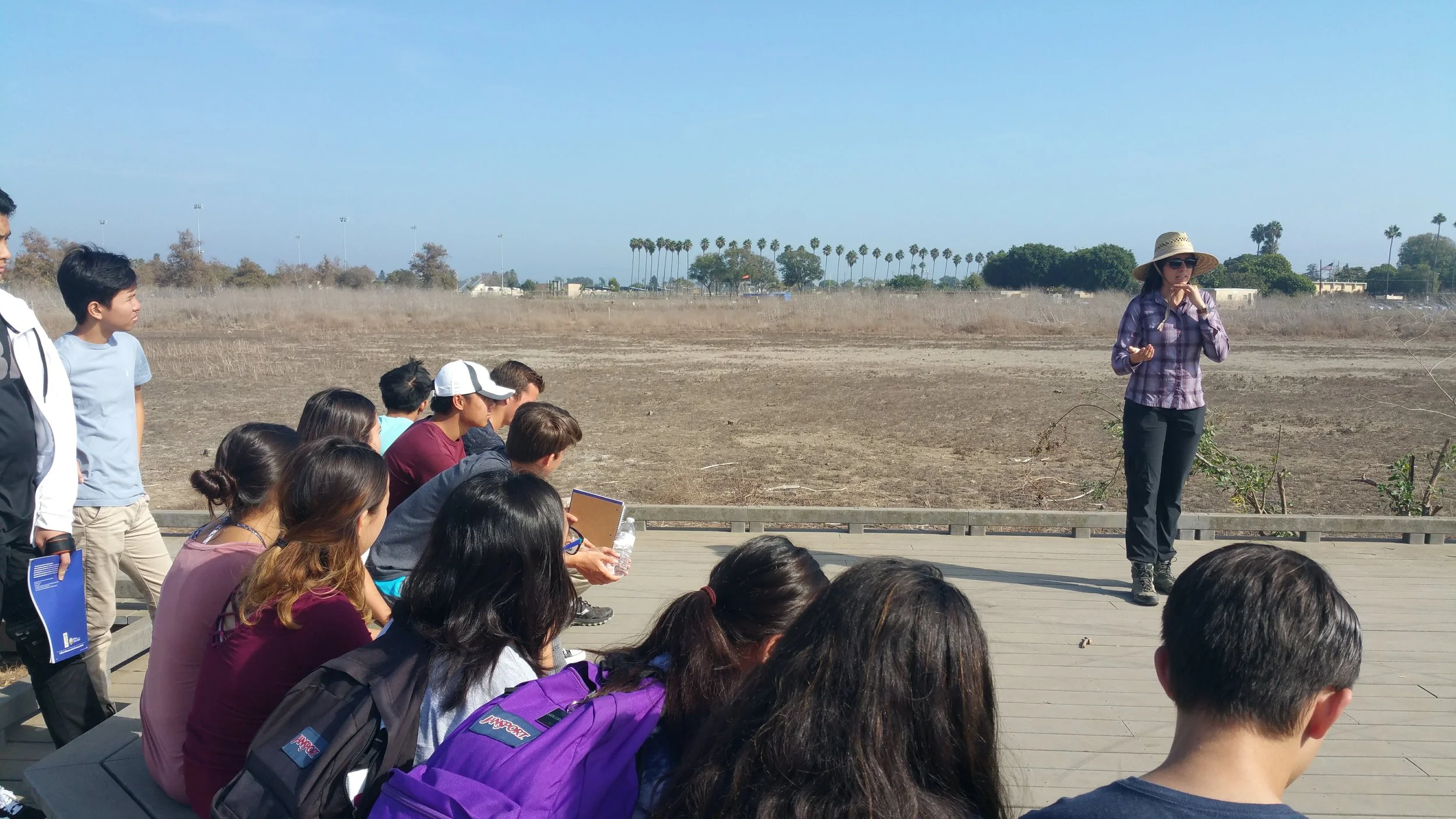 image of restoration manger giving presentation outside
