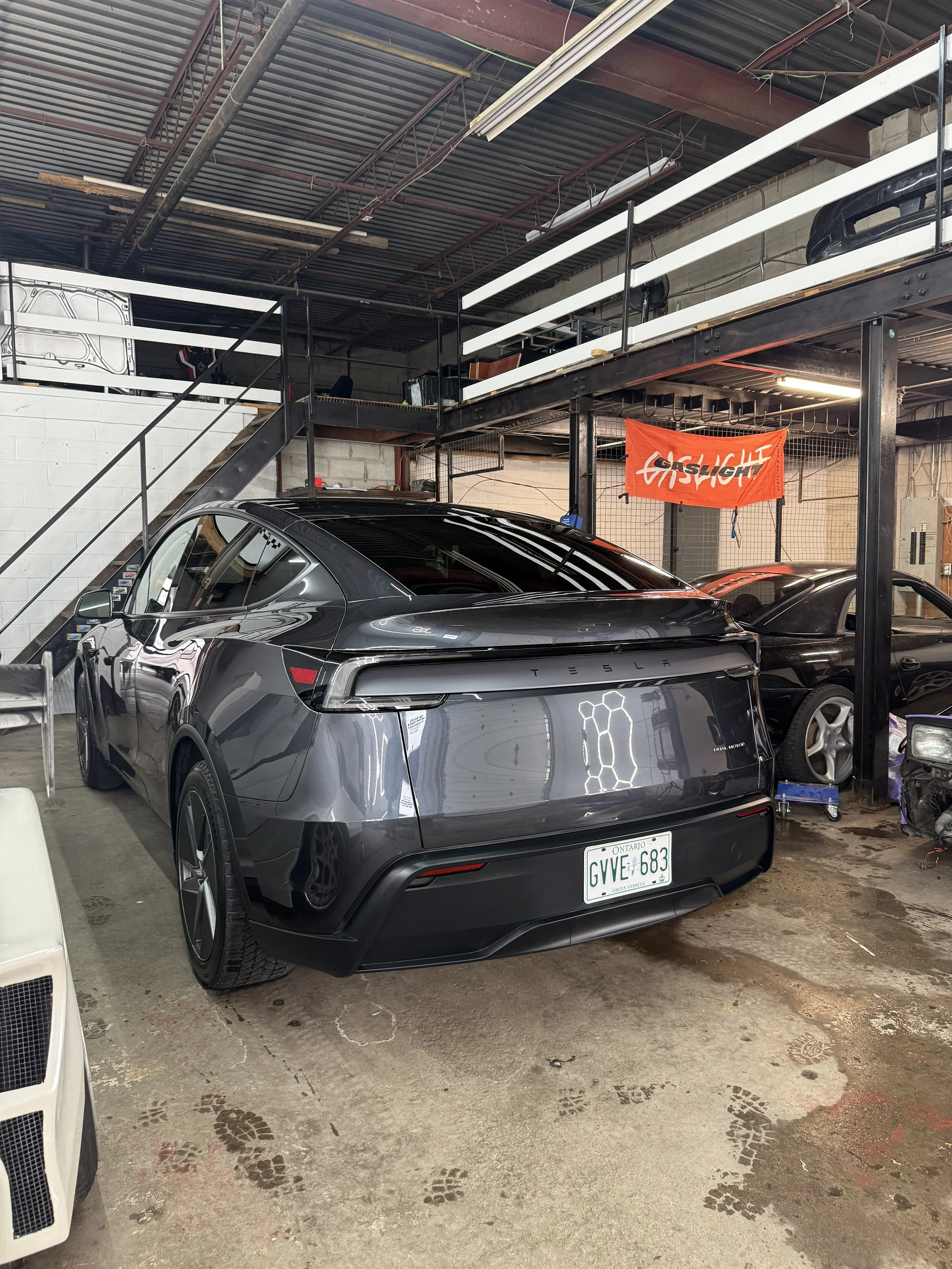 Black Tesla sedan after detailing inside the studio