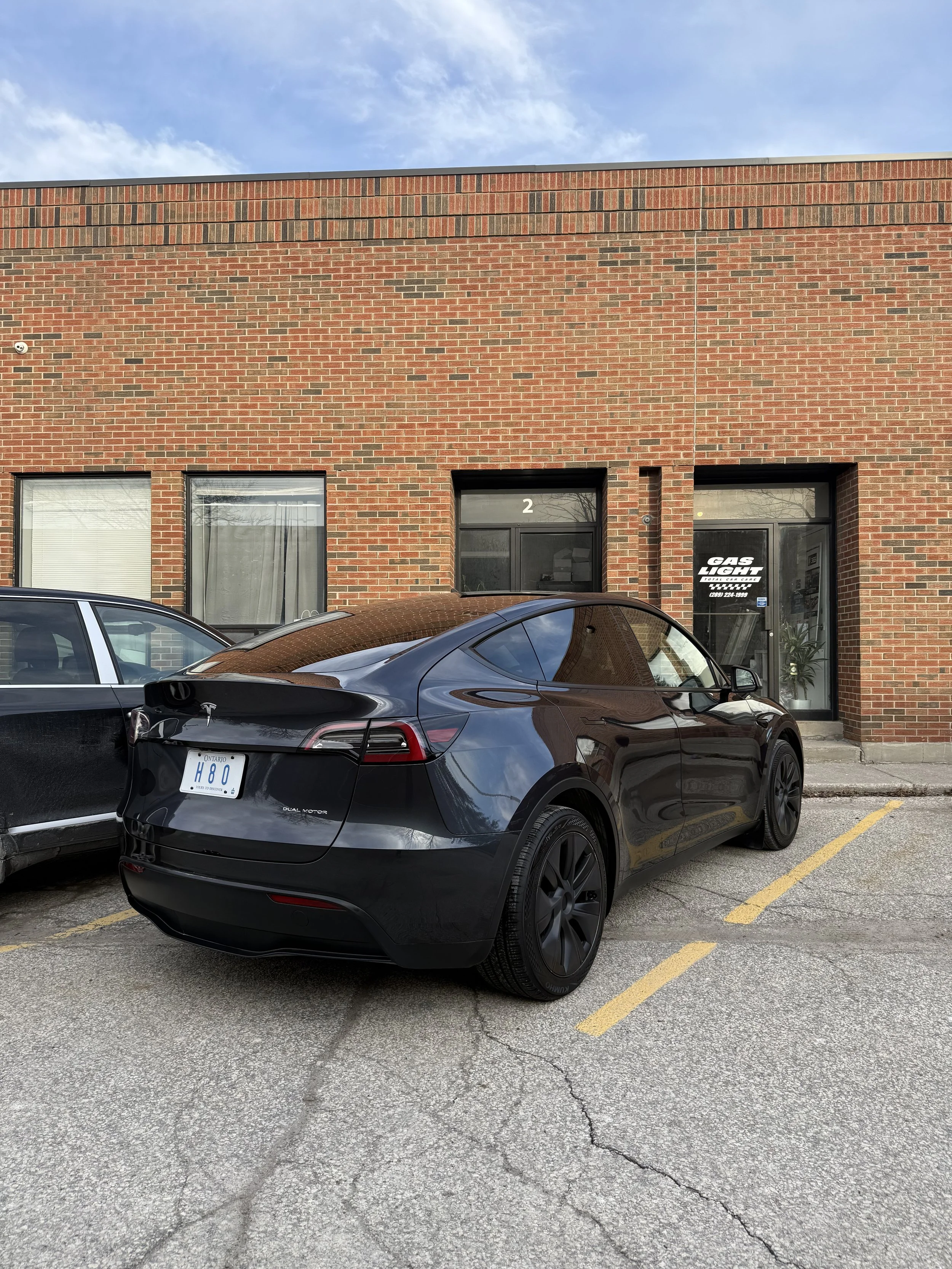 Black Tesla Model Y outside the Maple detailing studio
