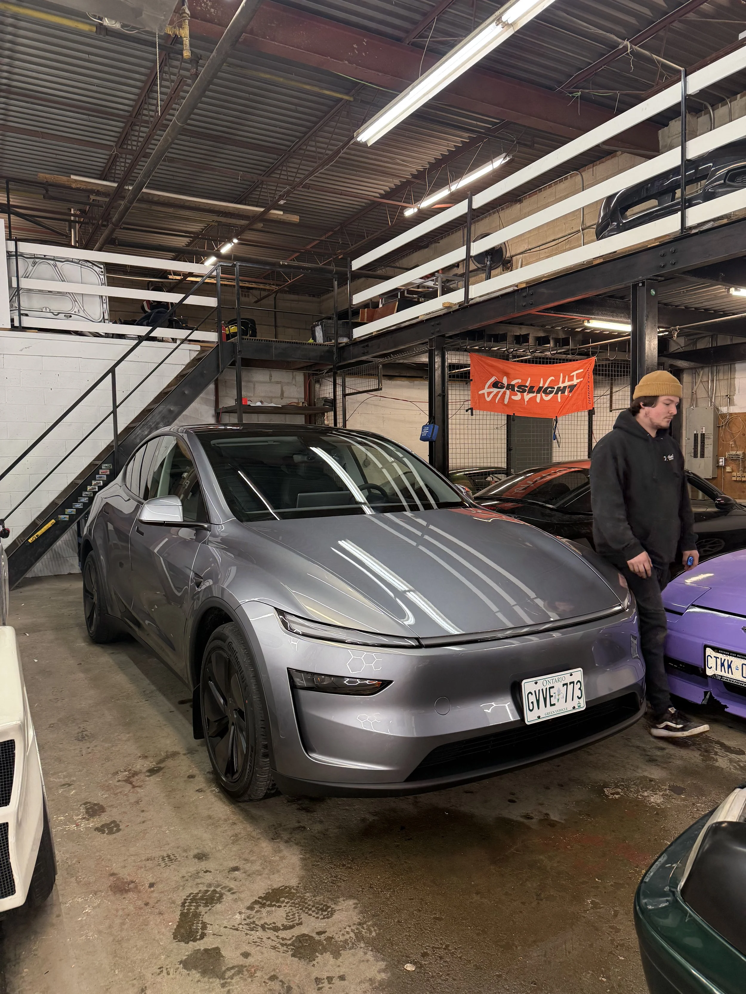 Silver electric SUV inside the detailing studio