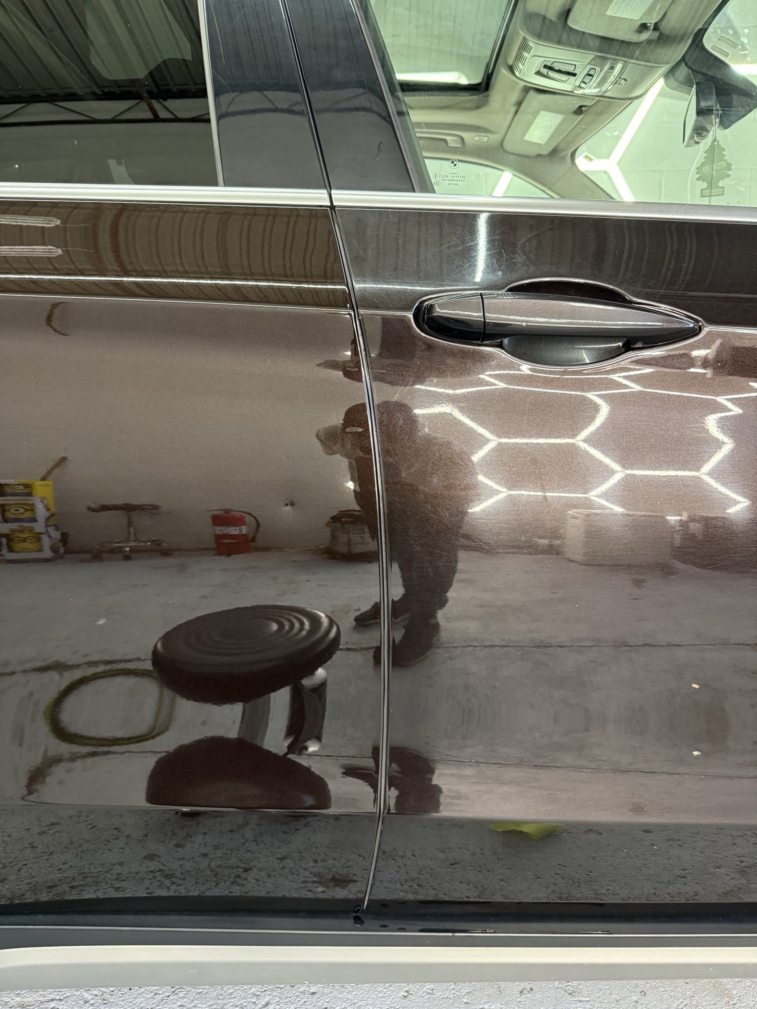 Brown BMW 50/50 paint correction: clearer corrected paint on the left and visible swirls on the right