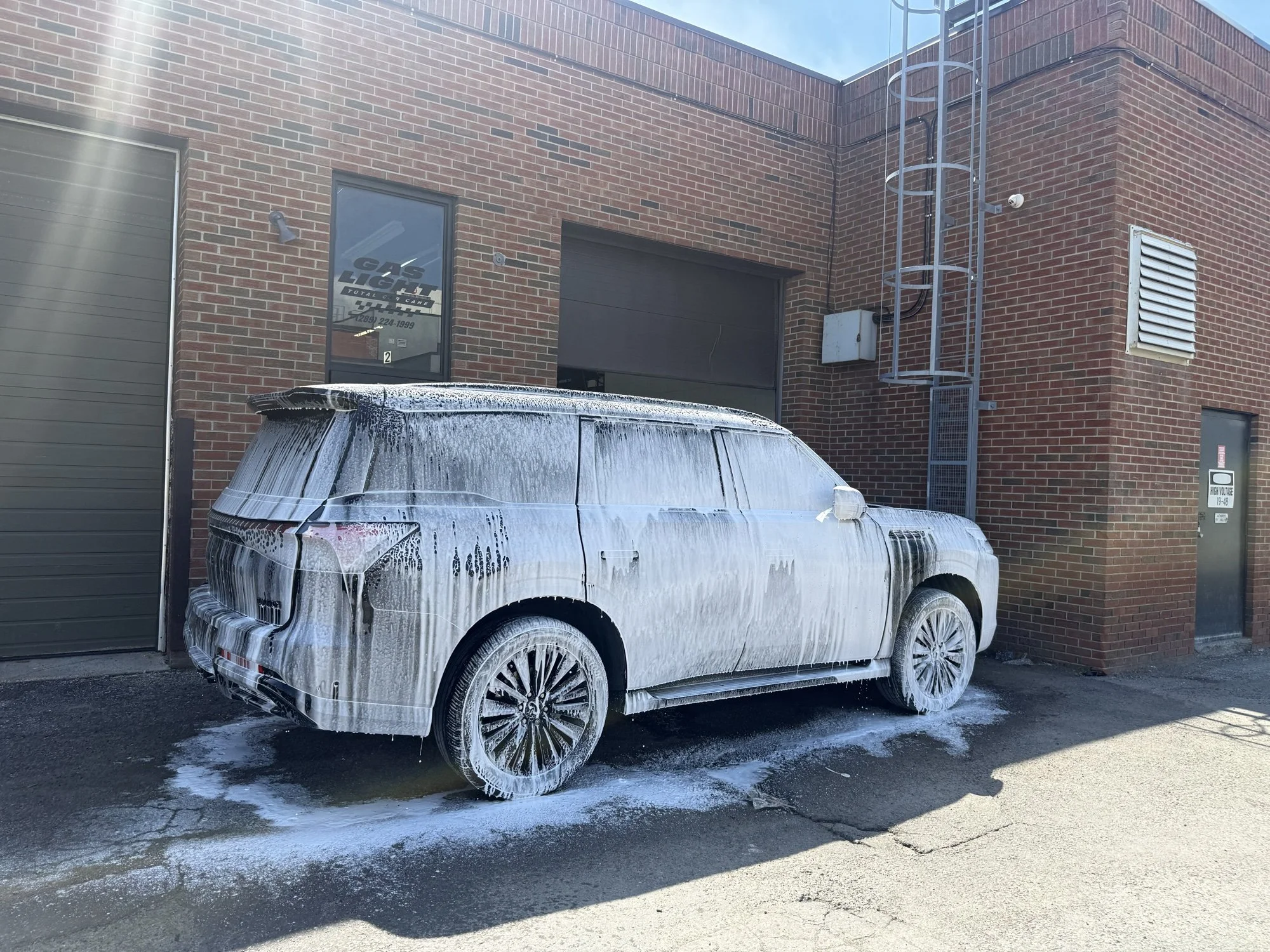 Range Rover covered in wash foam outside the Maple studio