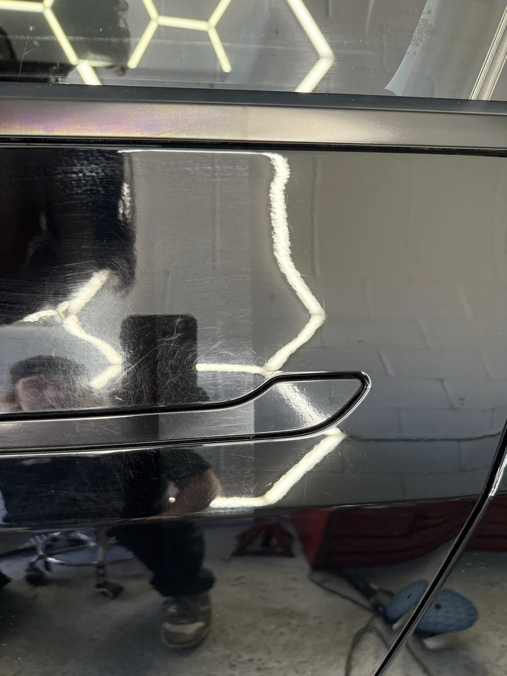 50/50 paint correction with swirl marks on the left and a clearer finish on the right
