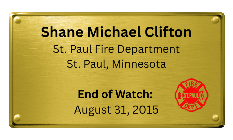Brass plaque with engraved text stating: "Shane Michael Clifton, St. Paul Fire Department, St. Paul, Minnesota, End of Watch: August 31, 2015" and a red fire department emblem on the lower right corner.
