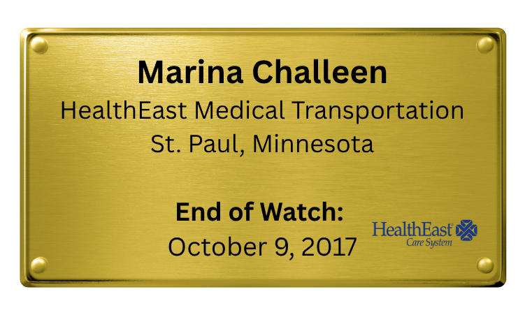 A gold-colored nameplate with black text displaying the name 'Marina Challeen' from HealthEast Medical Transportation in St. Paul, Minnesota. The sign indicates the end of a watch on October 9, 2017, and features the HealthEast Care System logo.