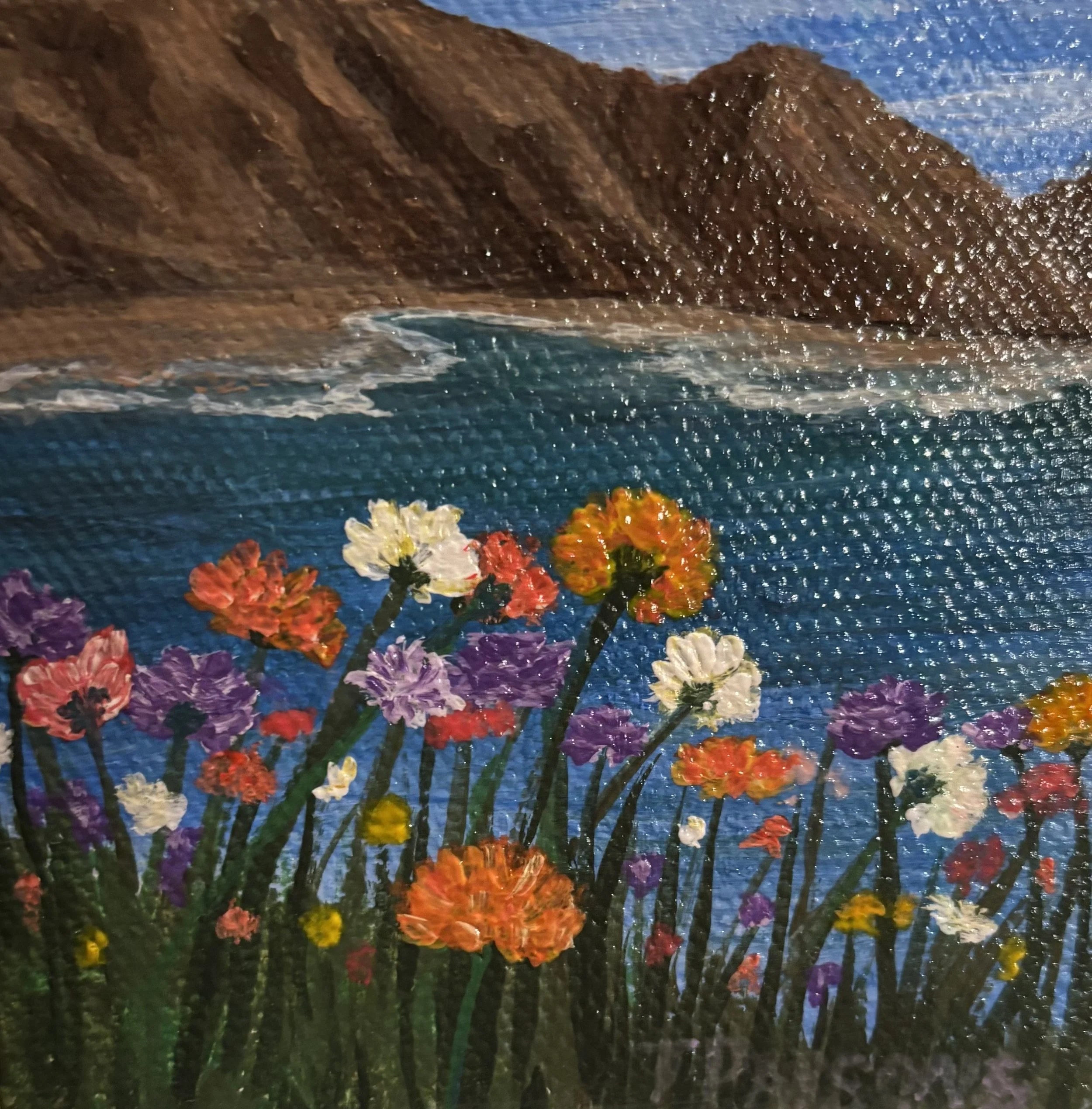 A painting titled "Peaceful Beyond the Field" showing close-ups of a colorful flower garden with vibrant flowers in shades of purple, red, orange, yellow, and white, set against a dark background with some greenery visible at the bottom.