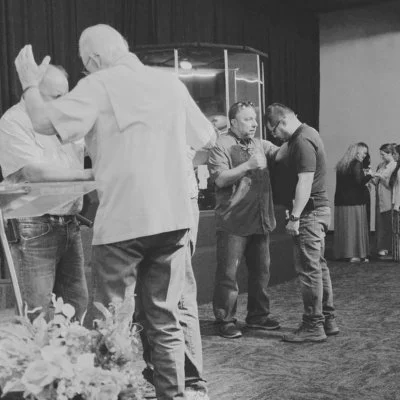 People at the alter praying and receiving prayer.