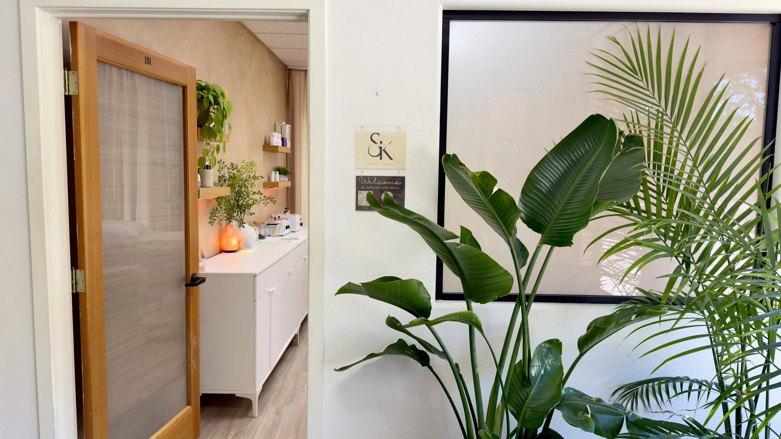 Interior entrance of Waxed by Shannon waxing studio in Vacaville California showing treatment room and S&K Aesthetics sign