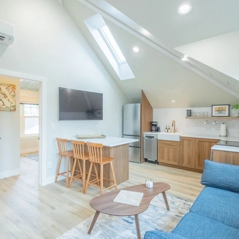 Fully equipped pet-friendly kitchen with island seating, smart TV, and open living area in our Denver rental
