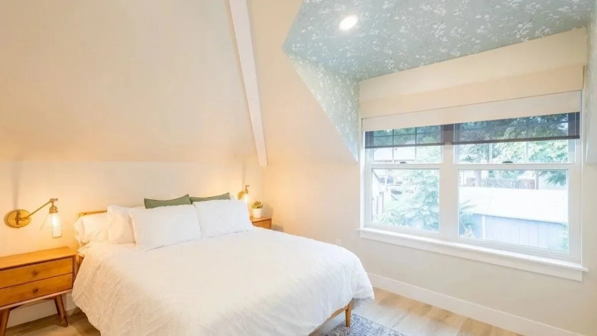 Second queen bedroom with soft natural light — sleeps up to five guests across two bedrooms and a sofa bed