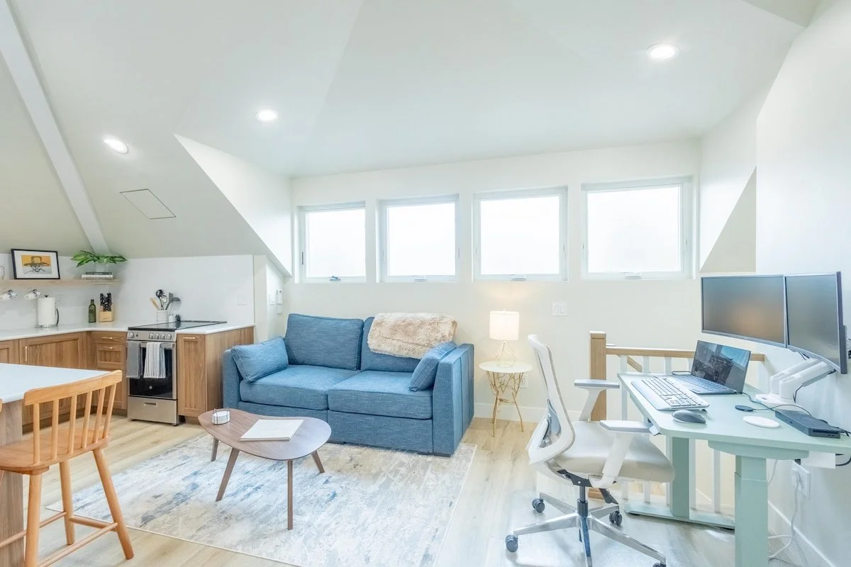 Bright open-plan living space of The Sunnyside Carriage House, a two-bedroom vacation rental in Denver