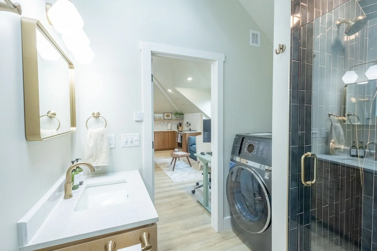 Stocked bathroom with in-unit washer and dryer, fresh towels, and everyday essentials provided