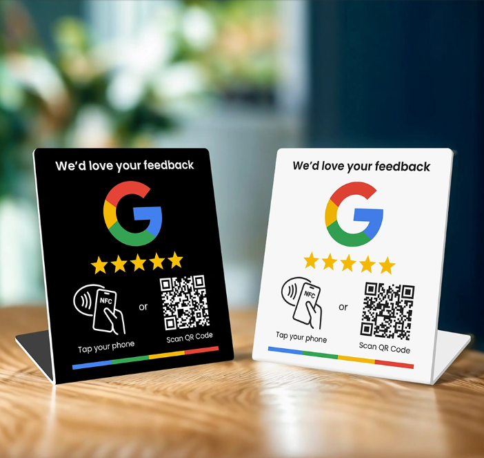 Two smart signss, one black and one white, with Google feedback request signs on a wooden table.