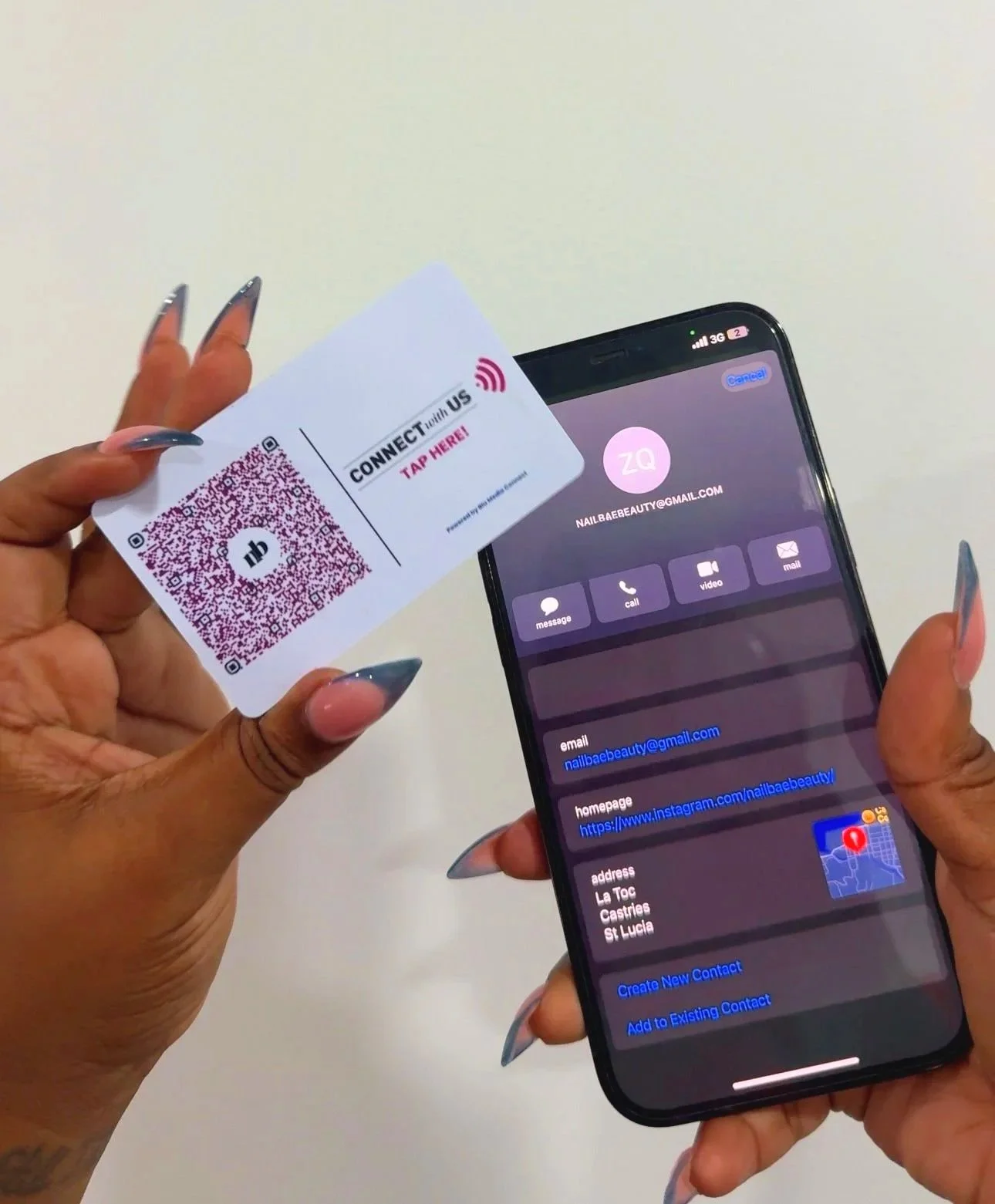 A person holding a QR code card in one hand and a smartphone displaying contact details for 'Nail Bae Beauty' in the other hand.