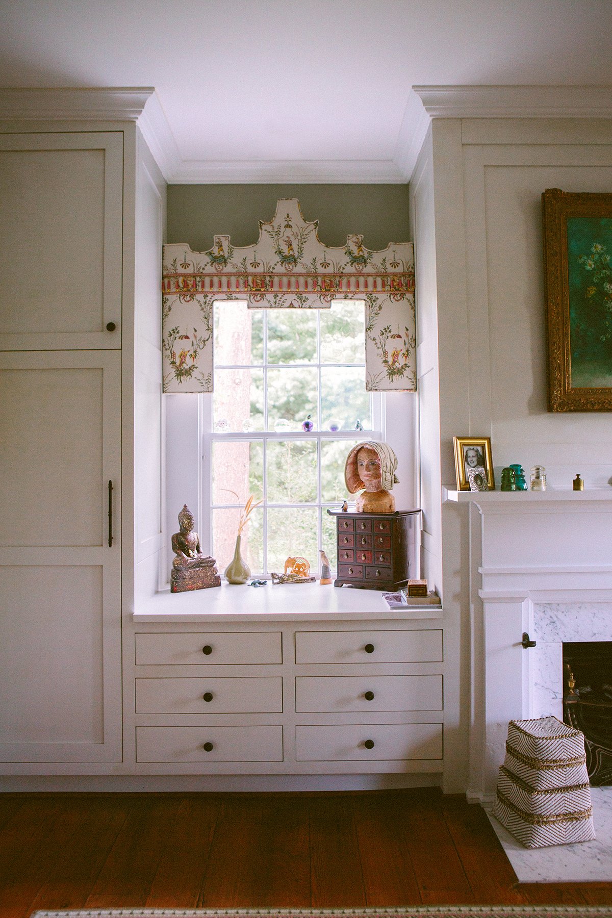 Architectural interior image of shelving, a window, sage paint, and memorabilia with a fireplace. Photographed at a private estate in Lancaster Ohio.