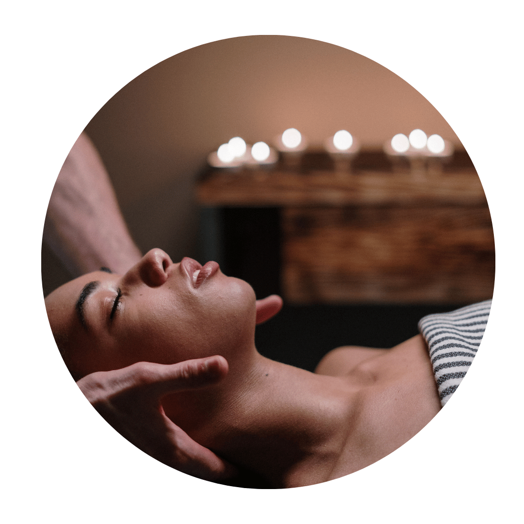 A pregnant woman lying comfortably while receiving a gentle prenatal massage to relax her muscles ahead of childbirth.