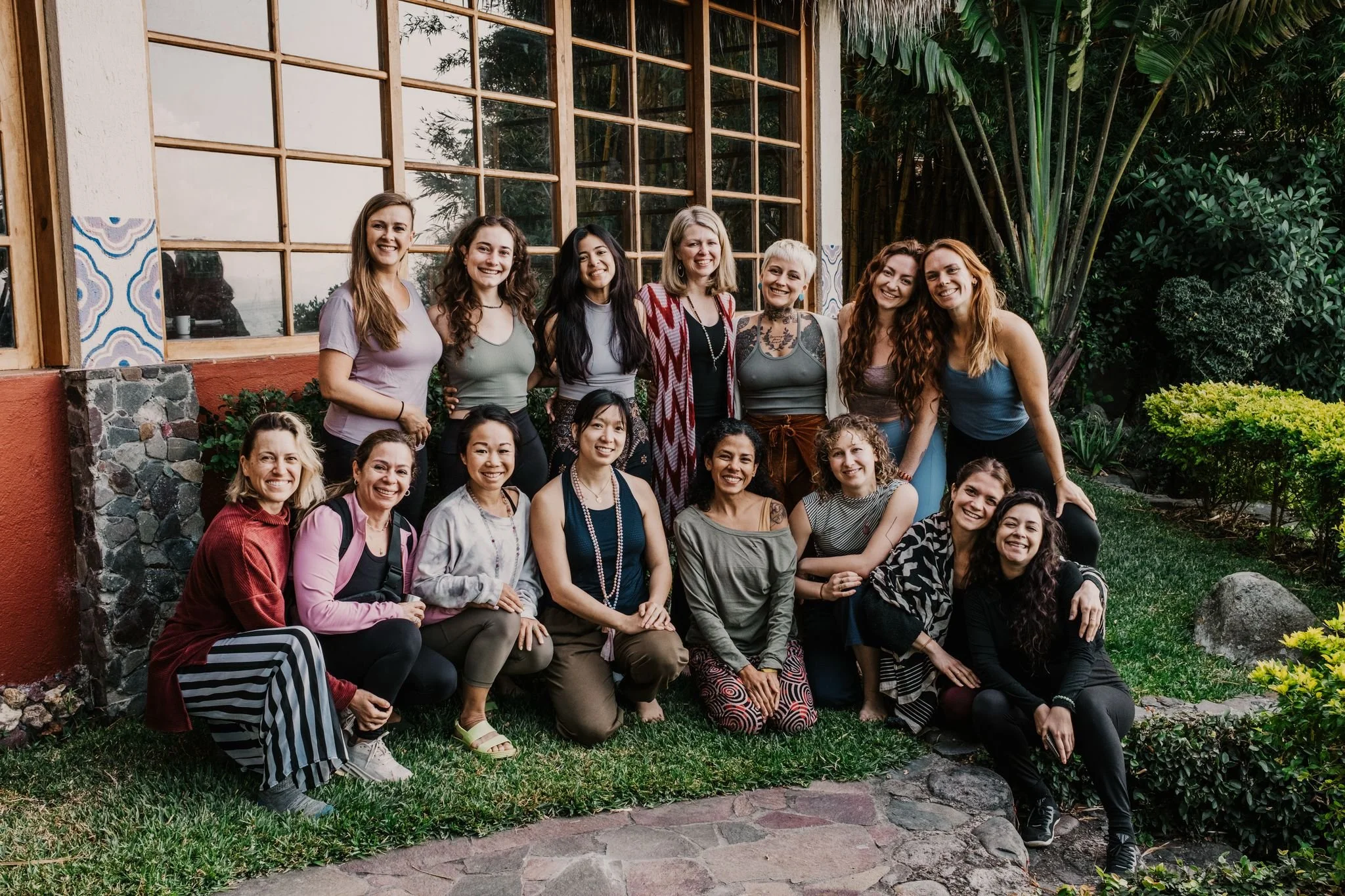 Ale la Doula smiling in a group portrait at the Doula School International.