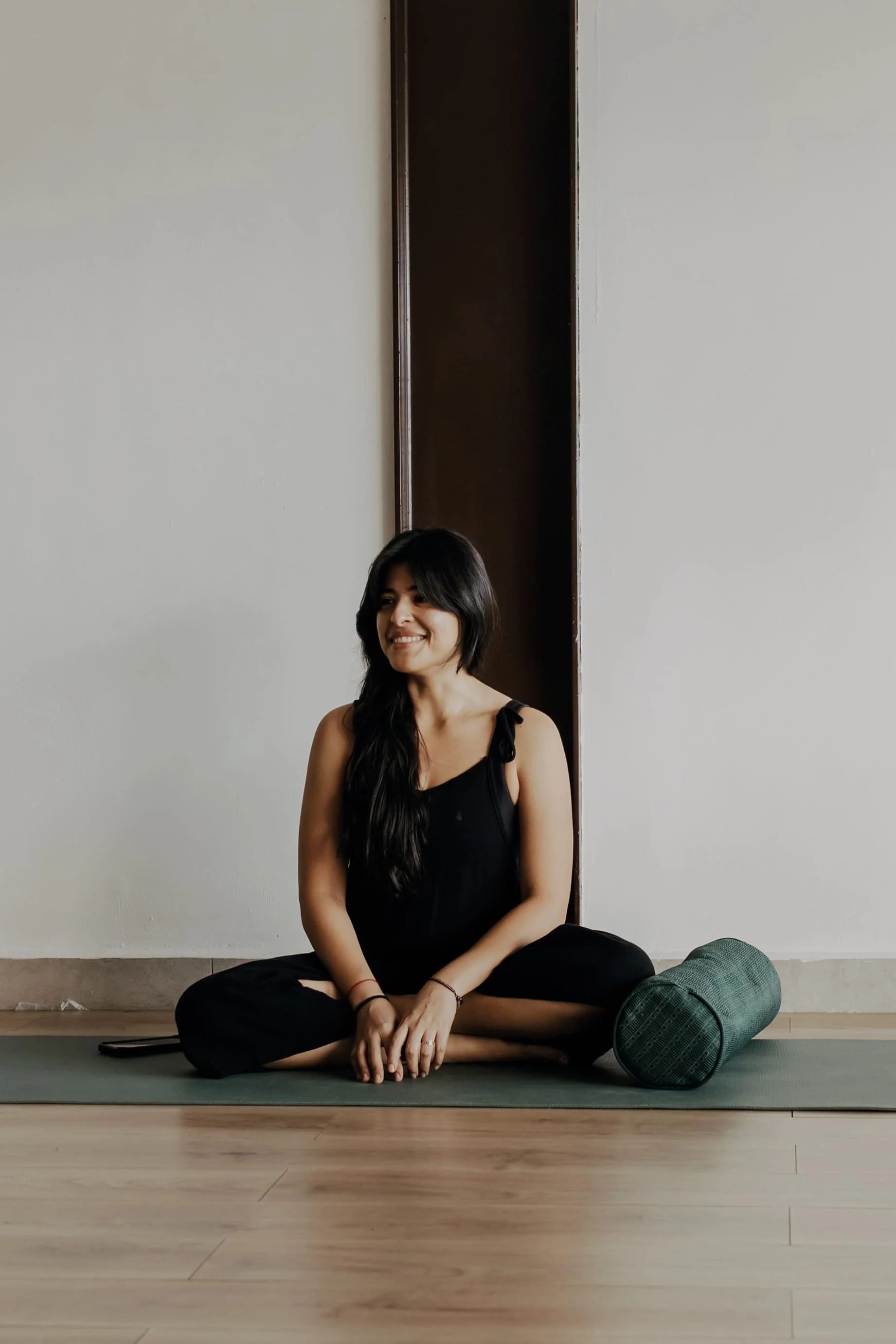 Ale la Doula smiling while listening to her yoga class.
