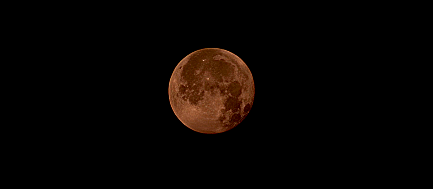 A "Buck Moon", visible through the smoke from forest fires, visible in a dark night sky with no clouds taken by H1M Photography July 31 2026.