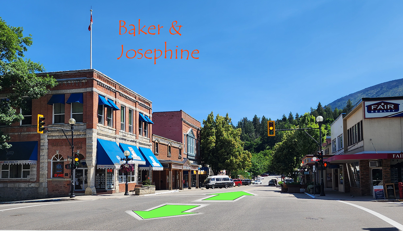 A sunny small-town street with brick buildings, some with blue awnings, and traffic lights. Green arrows are drawn on the road pointing straight ahead. The image has red text that reads 'Baker & Josephine' in the upper left corner.