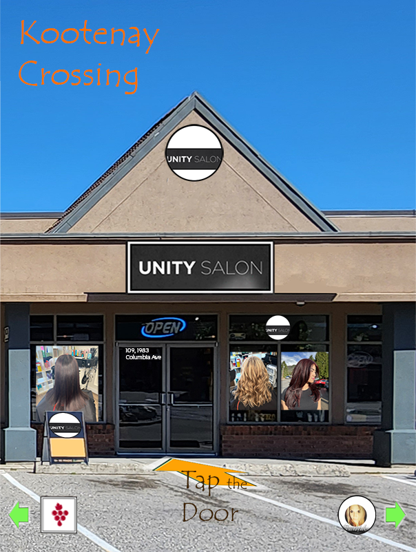 The front of a salon named Unity Salon with its sign above the entrance. There are two posters in the windows showing women with styled hair, and a small chalkboard sign on the sidewalk. An