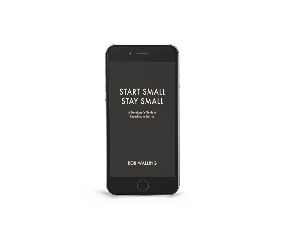 A smartphone displaying the book cover for 'Start Small Stay Small' by Rob Walling, placed on a gray surface with a black background.