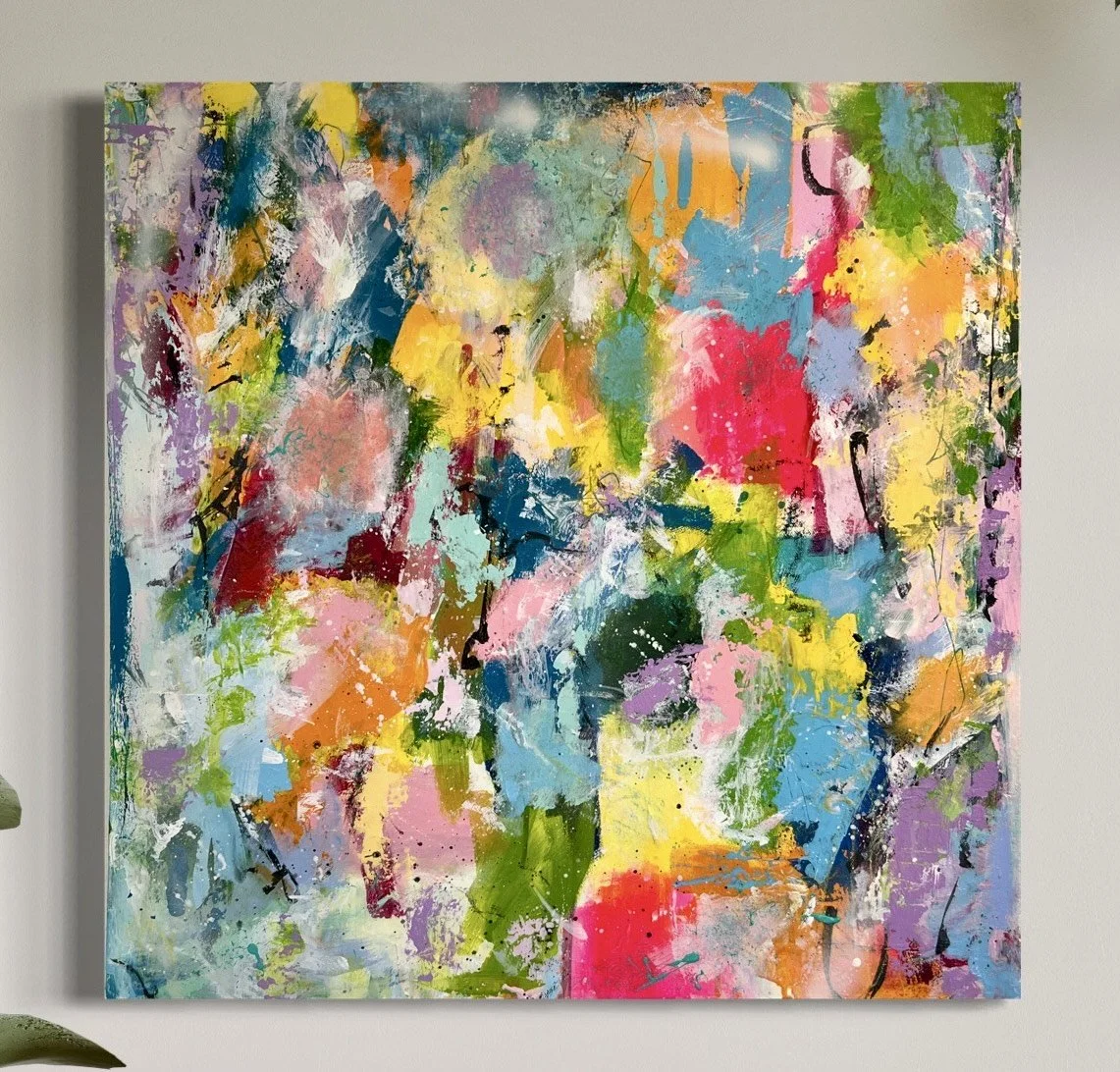 Colorful abstract expressionist painting with splashes of pink, yellow, blue, green, and purple on a white canvas.