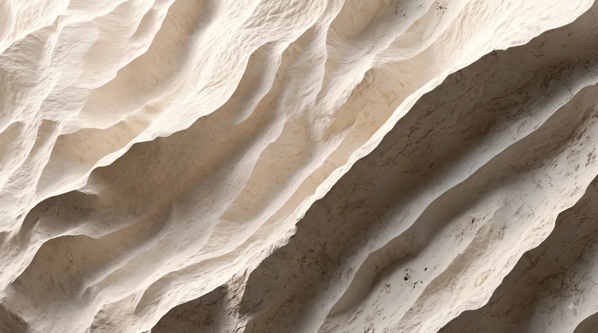 Close-up of layered, textured white rock formations with various shadows and natural patterns.