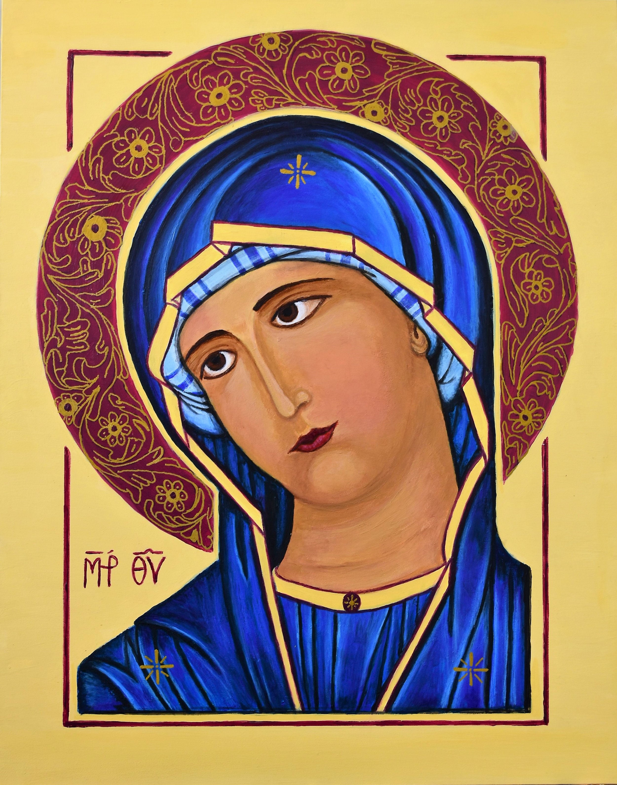 Religious icon of Virgin Mary with a yellow background, blue and gold ornate framing, and Greek text reading 'Μήτηρ Θεού'.