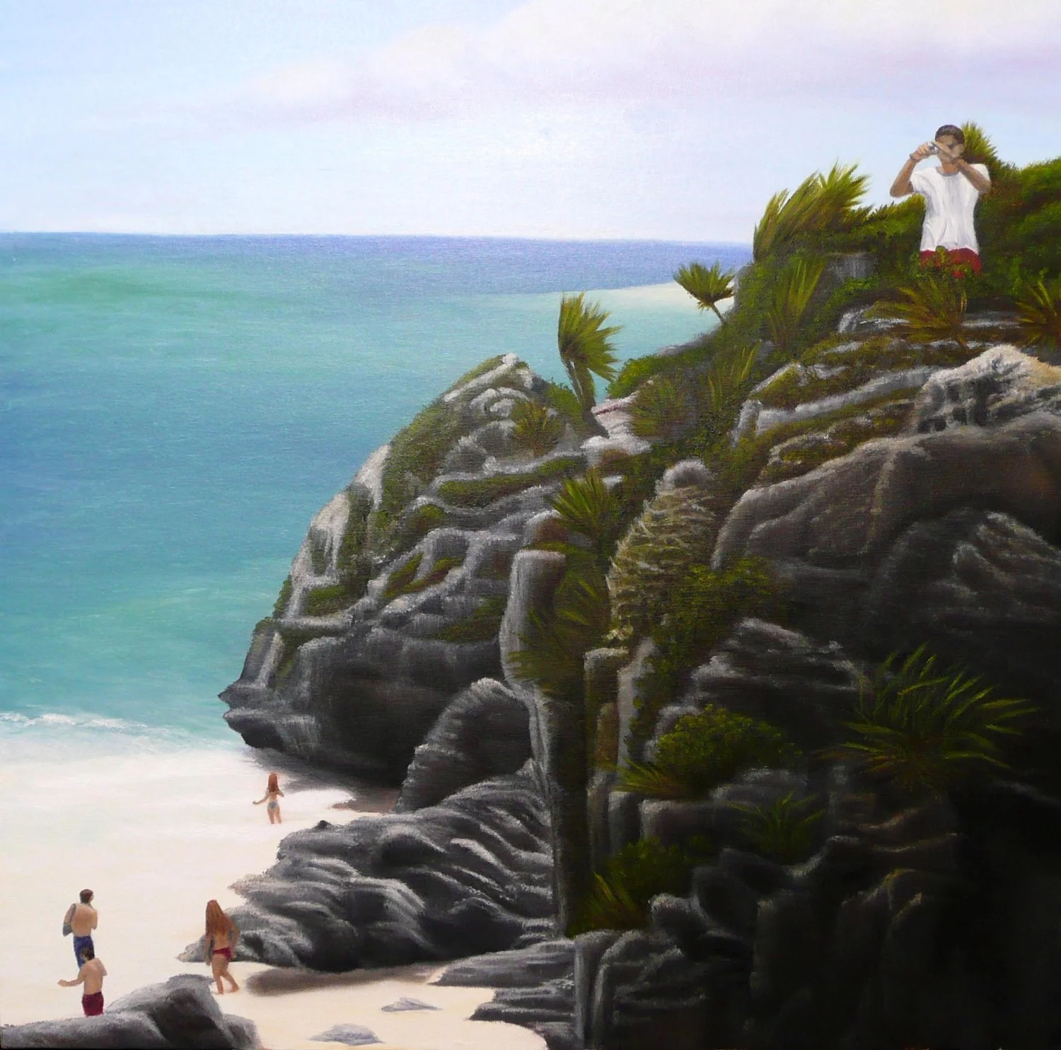 A woman standing on a sandy beach near large rocks and green plants, looking towards the ocean, with several people walking on the beach and a person taking a photo from a rocky cliff.
