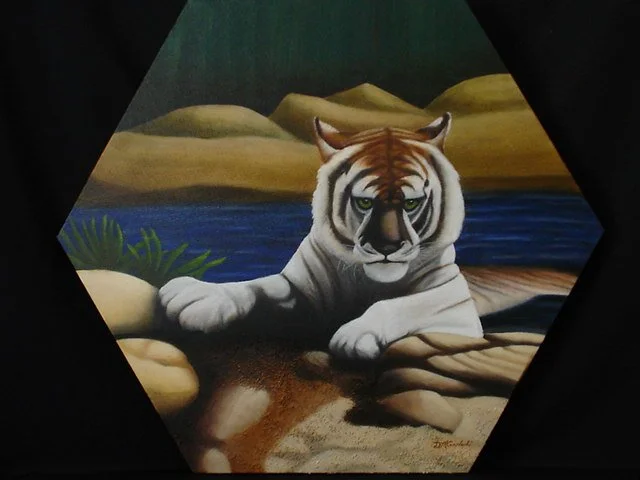 Painting of a tiger lying on rocks near water with a landscape of hills and greenery in the background.