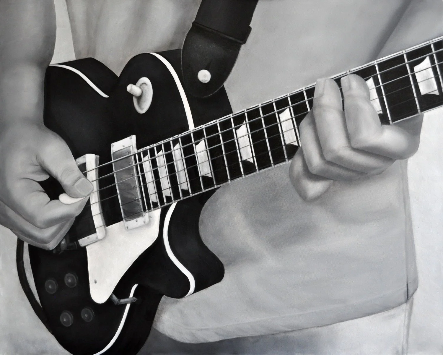 Black and white photo of a person's hands playing an electric guitar, with the person wearing a long-sleeved black shirt.