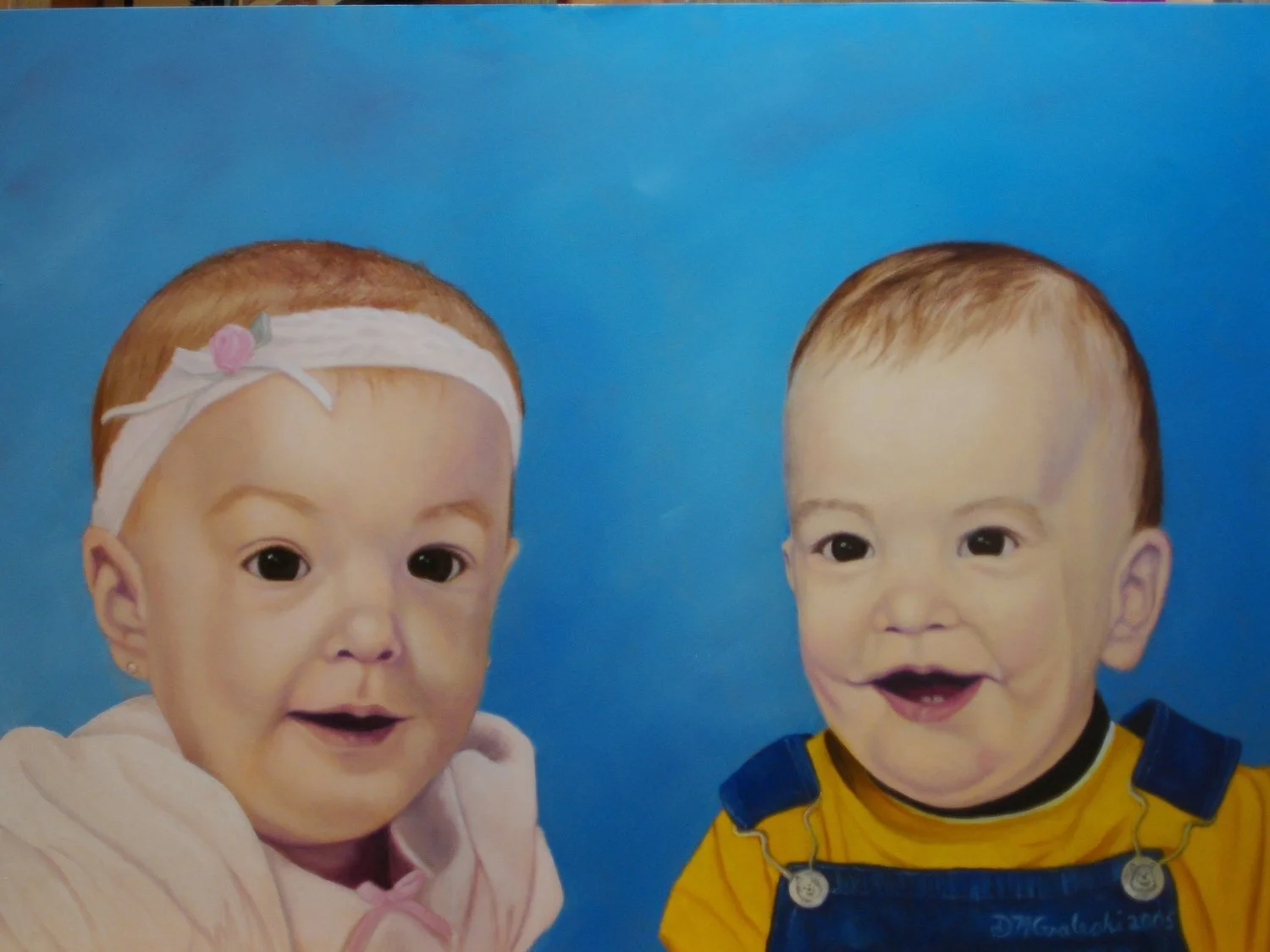 Painting of two smiling babies against a blue background, one girl with a white headband and pink embellishment, and one boy with short hair wearing yellow and blue overalls.