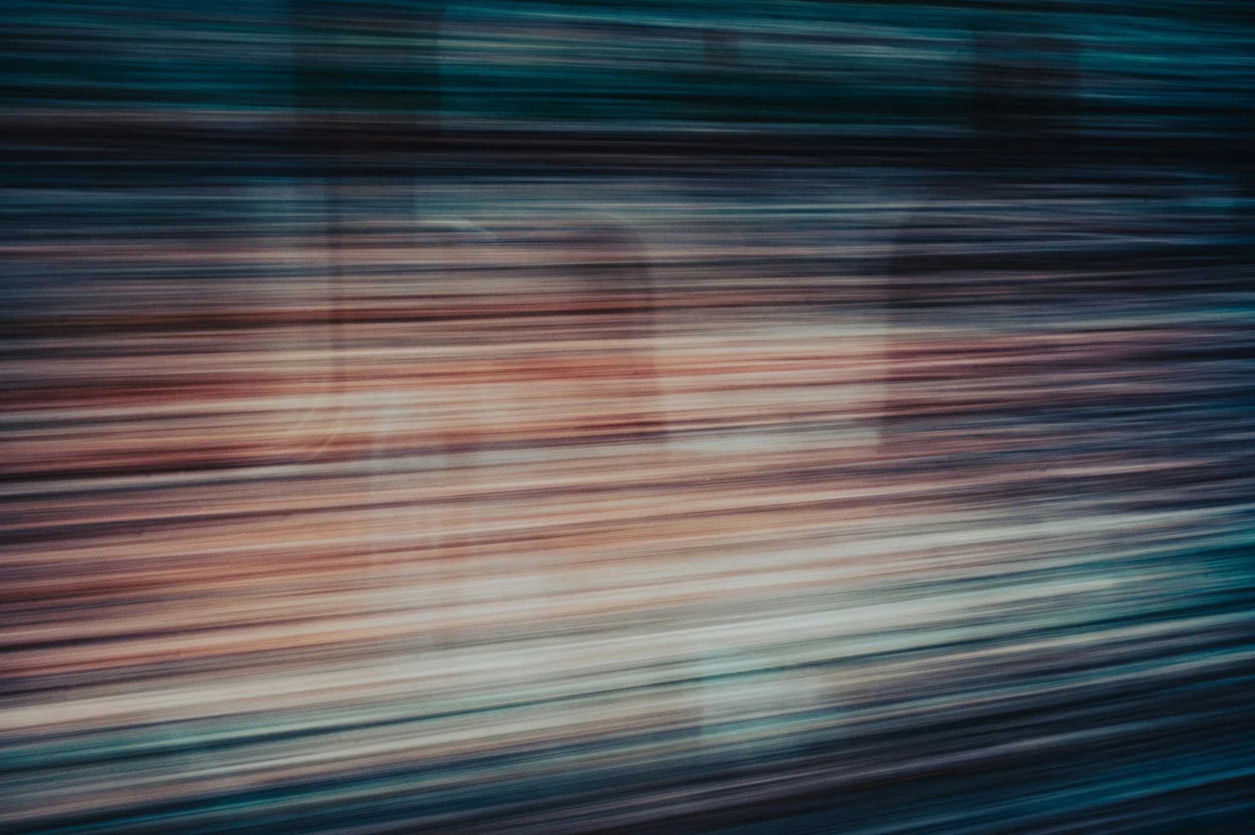 Blurred horizontal lines in various colors, creating an abstract pattern.