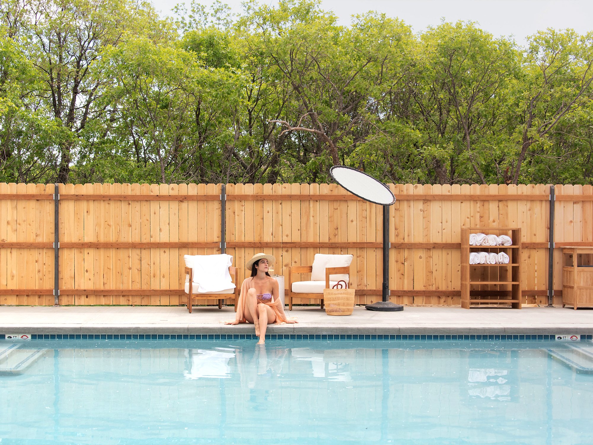 woman sitting on edge of the pool at Ofland Escalante