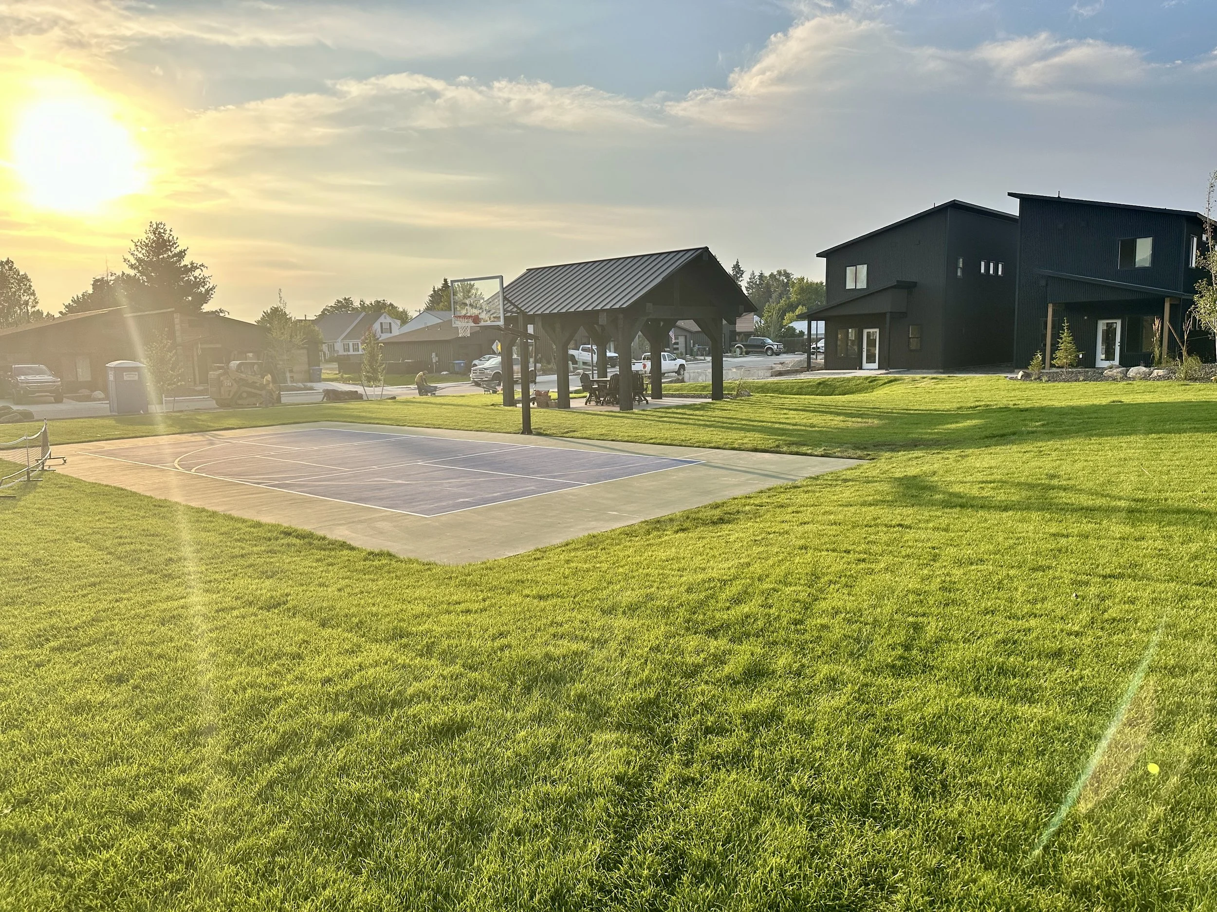Neighborhood park with a basketball court, picnic shelter, and open lawn