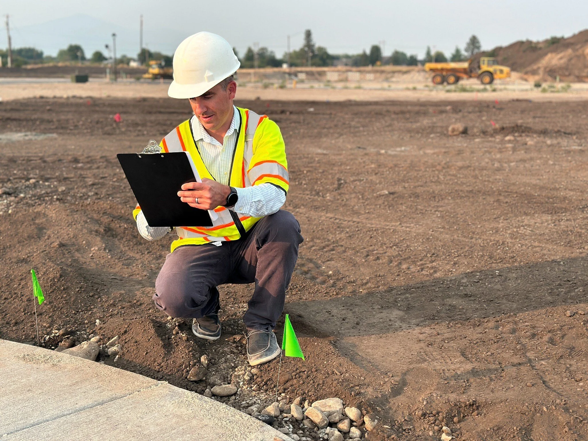 Darren Teal reviewing construction documents at an active project site.