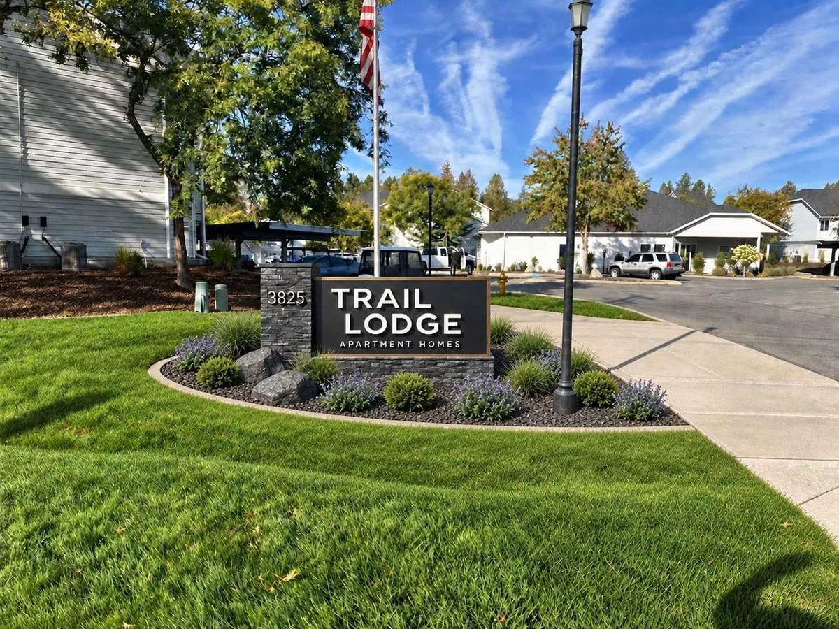 Proposed concept — not built. A more visible sign, low planting and a connected bed, with drainage preserved. September 2026 design development.