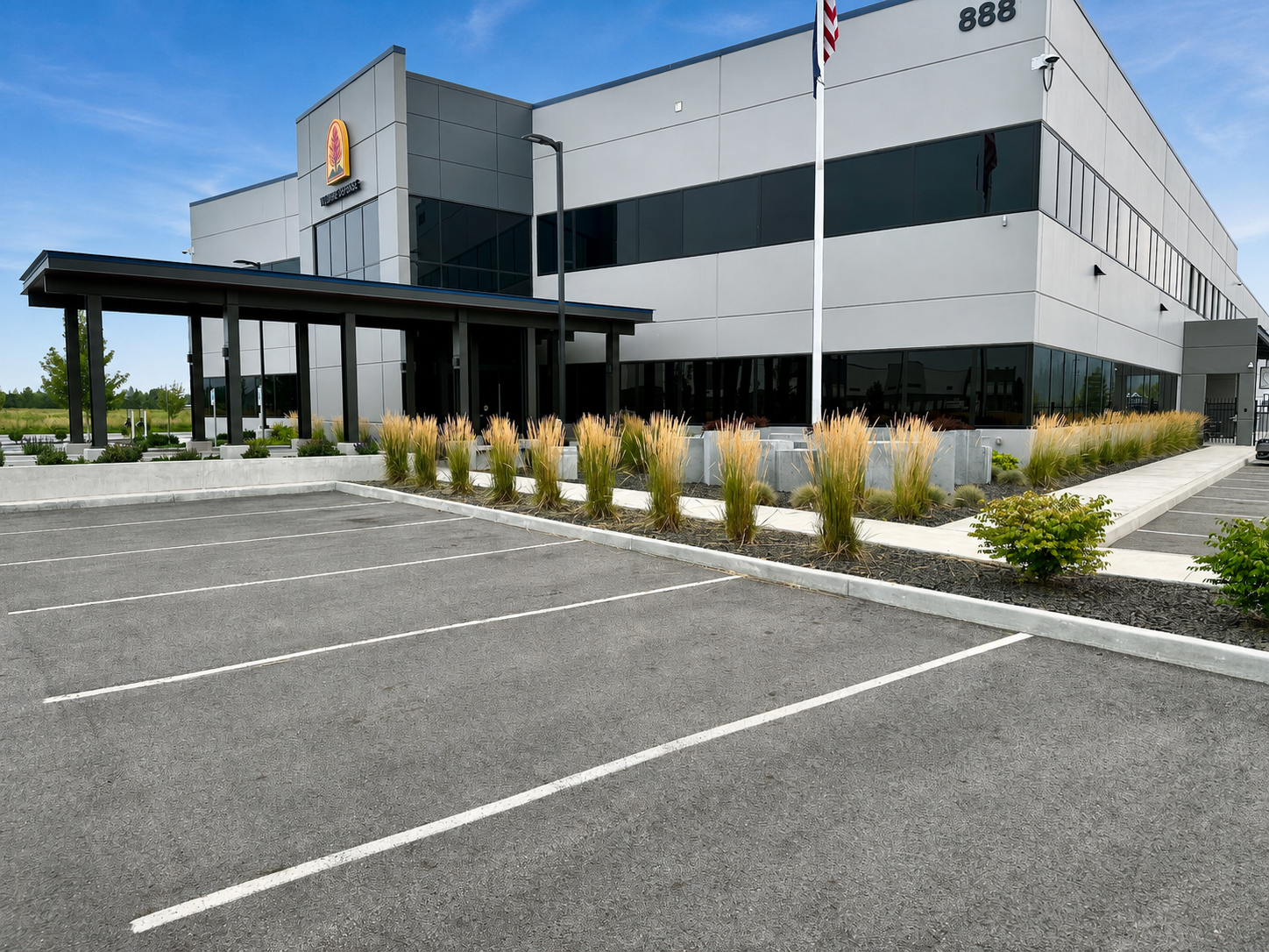 Wildfire Defense building exterior with ornamental grasses and concrete planter walls