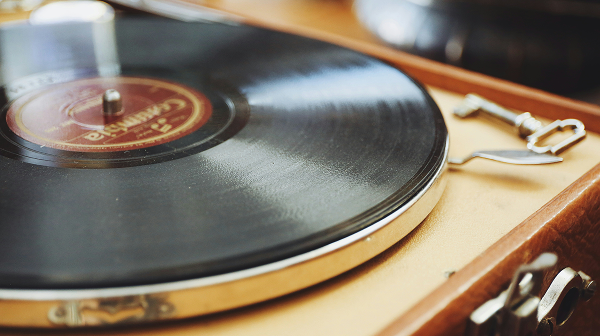A close-up of a vintage turntable playing a vinyl record.