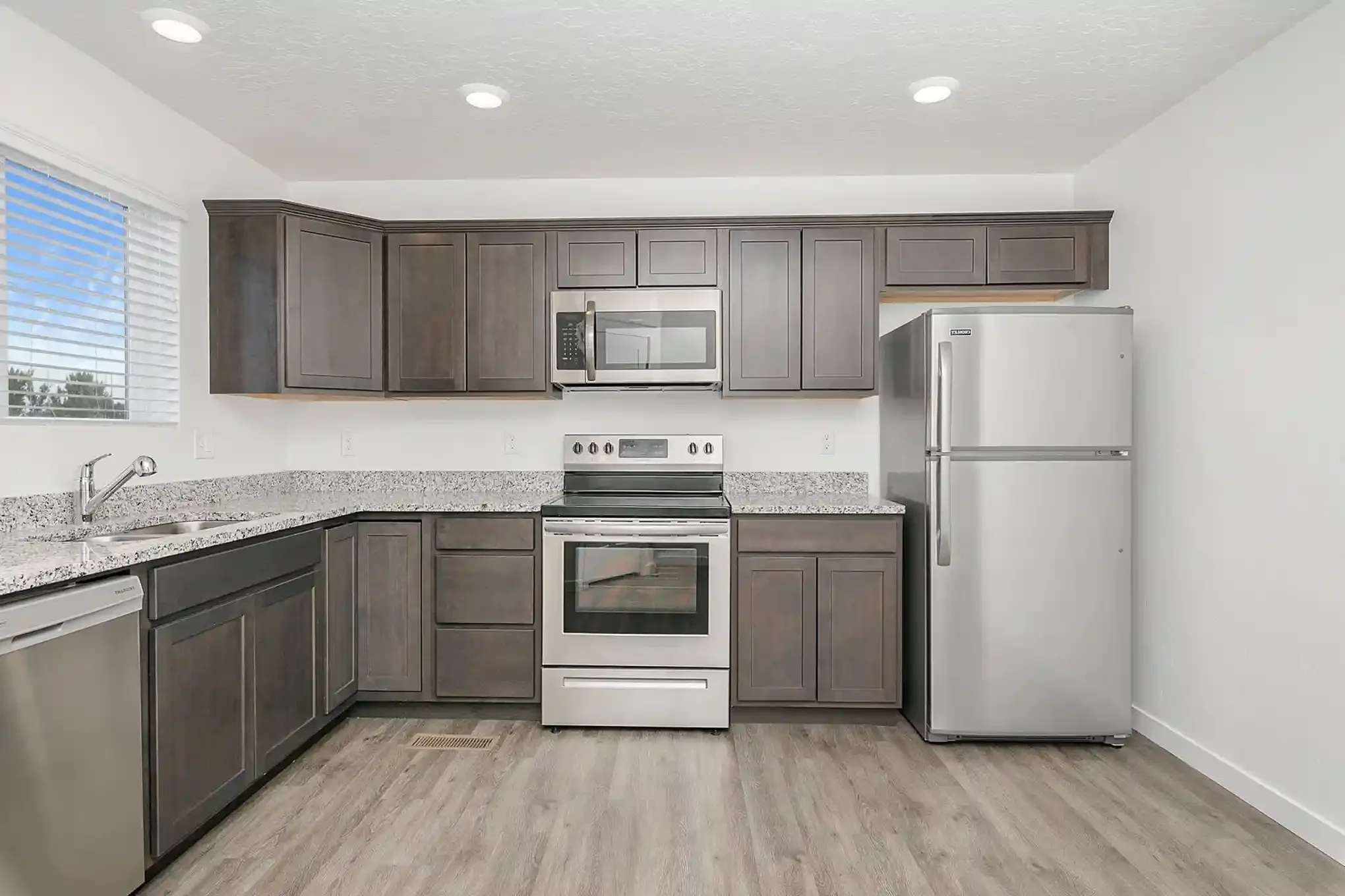 Kitchen interior at Laguna Farms – Delinda Townhomes in Nampa, Idaho, featuring doors, trim and interior finish work by West Construction Services.